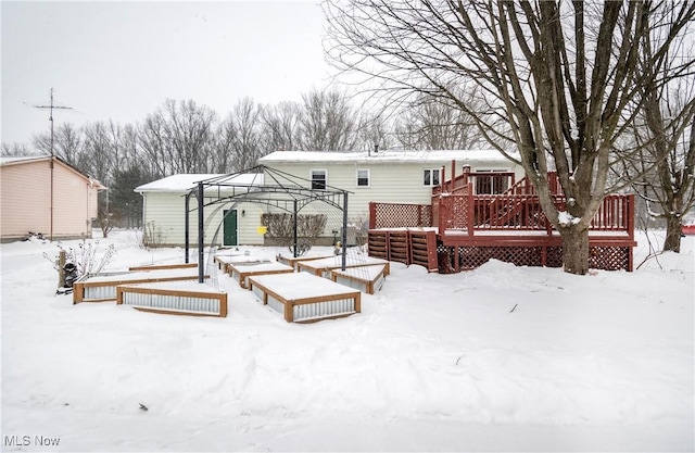 snow covered property featuring a gazebo and a wooden deck