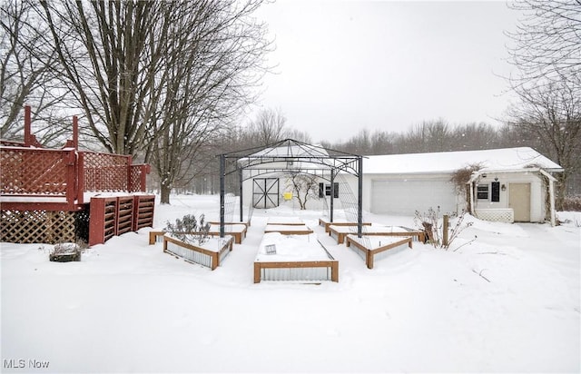 snowy yard featuring a garage