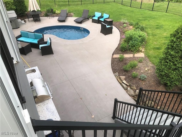 view of swimming pool featuring an outdoor hangout area, a patio area, a lawn, and sink