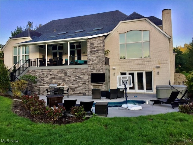 rear view of house with french doors and a patio