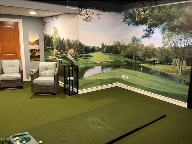 interior space with golf simulator and a water view