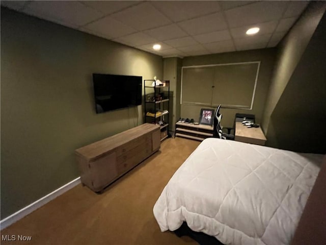 carpeted bedroom with a paneled ceiling