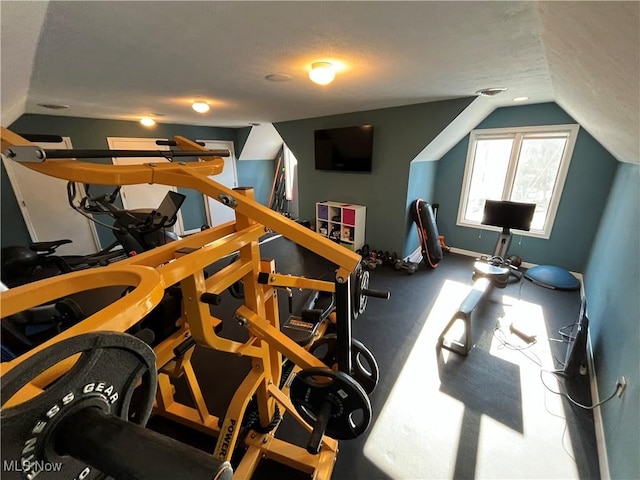 exercise room featuring a textured ceiling and lofted ceiling