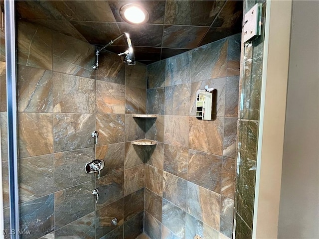 bathroom with a tile shower