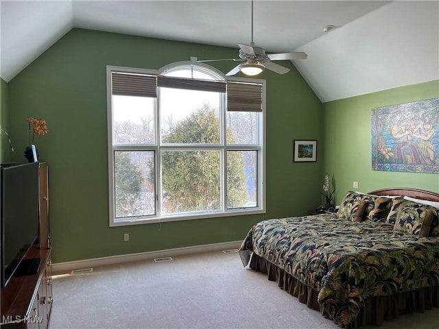 carpeted bedroom featuring ceiling fan, vaulted ceiling, and multiple windows