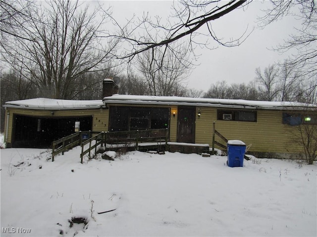 view of snow covered rear of property