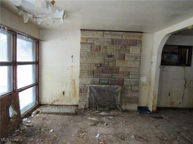 unfurnished living room with a stone fireplace