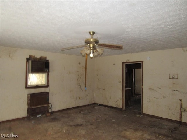 interior space with ceiling fan and a textured ceiling