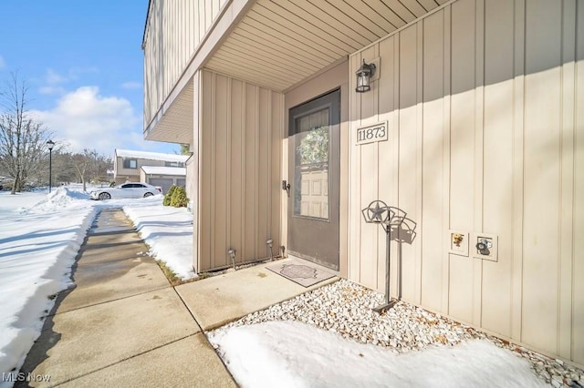 view of snow covered property entrance