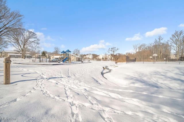 snowy yard with a playground