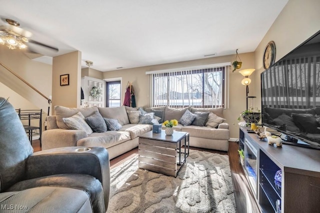 living room featuring ceiling fan and hardwood / wood-style flooring