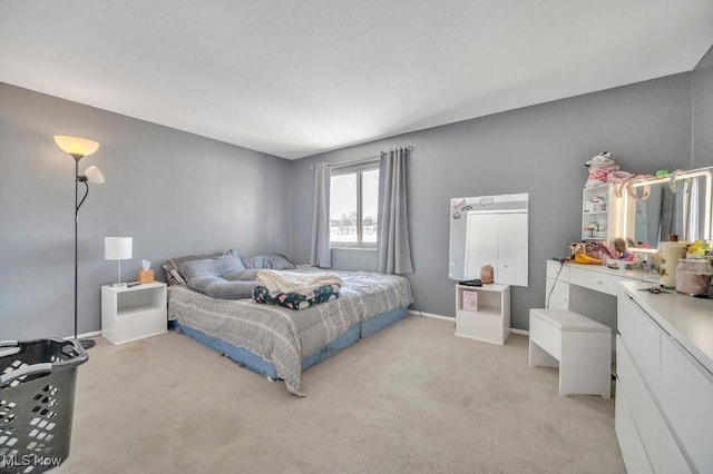 bedroom featuring light carpet