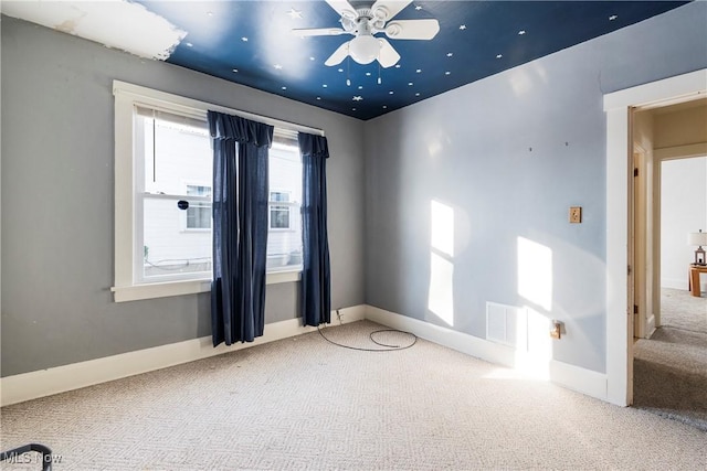 empty room with ceiling fan and carpet