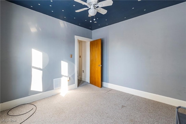 spare room with carpet and ceiling fan