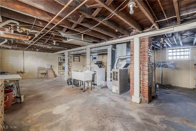 basement with heating unit and washer / dryer