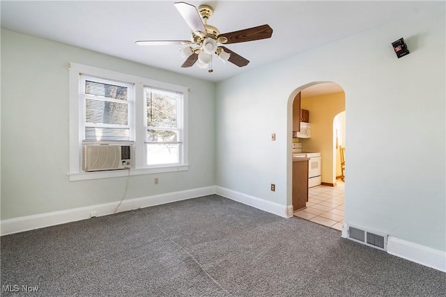 spare room featuring cooling unit, ceiling fan, and light colored carpet