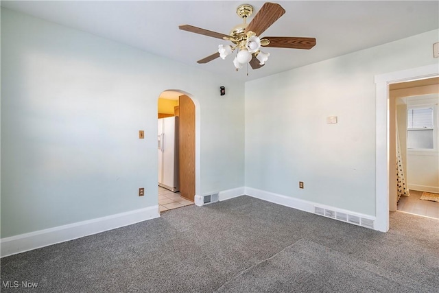 spare room with light carpet and ceiling fan