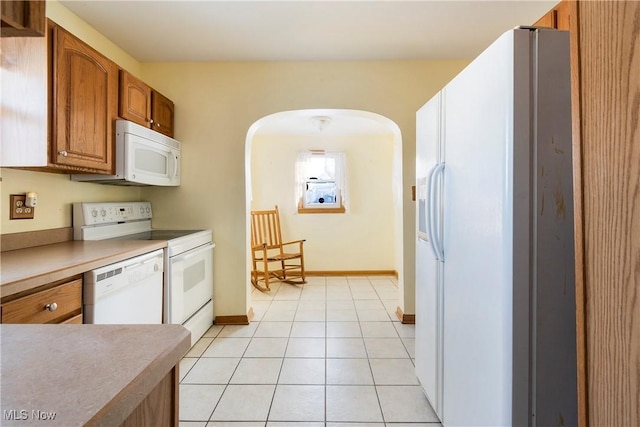 kitchen with white appliances and light tile patterned floors