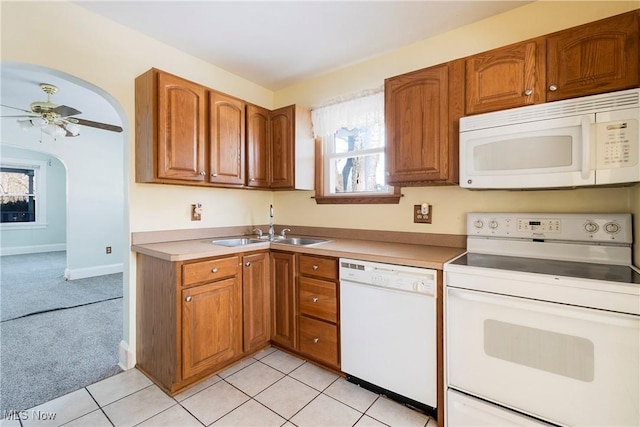 kitchen with ceiling fan, sink, white appliances, and light carpet