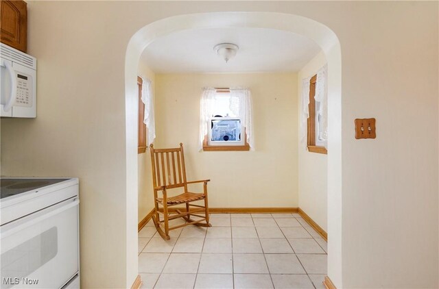 corridor with light tile patterned floors