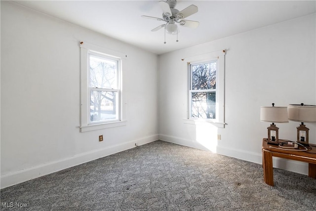 spare room with ceiling fan and carpet