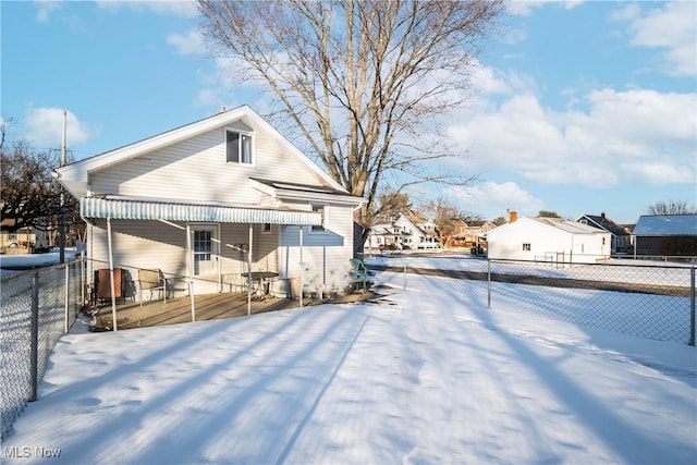 snow covered house with covered porch