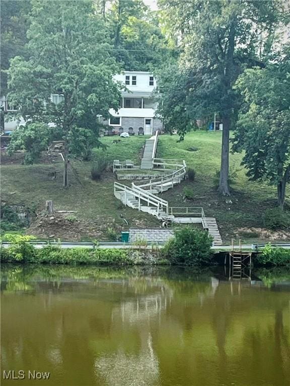 exterior space featuring a dock and a water view