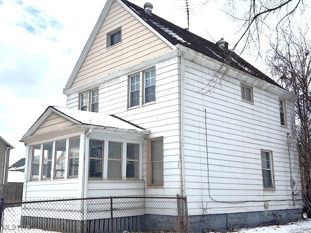 view of side of home with a sunroom