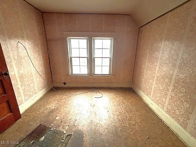 spare room with vaulted ceiling