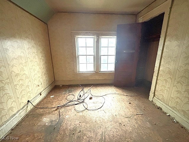 spare room featuring vaulted ceiling