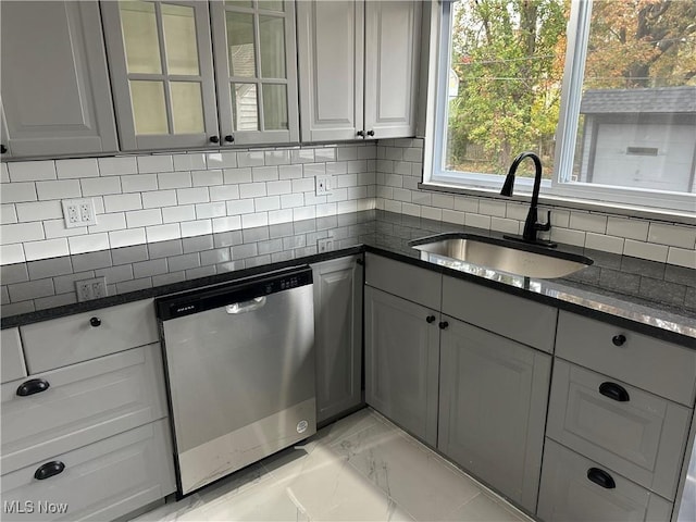 kitchen featuring gray cabinets, dishwasher, tasteful backsplash, and sink