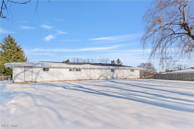 view of snow covered rear of property