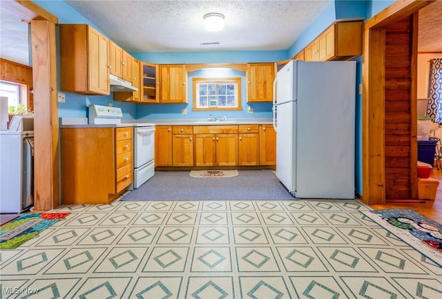 kitchen with a textured ceiling, sink, washer / clothes dryer, and white appliances