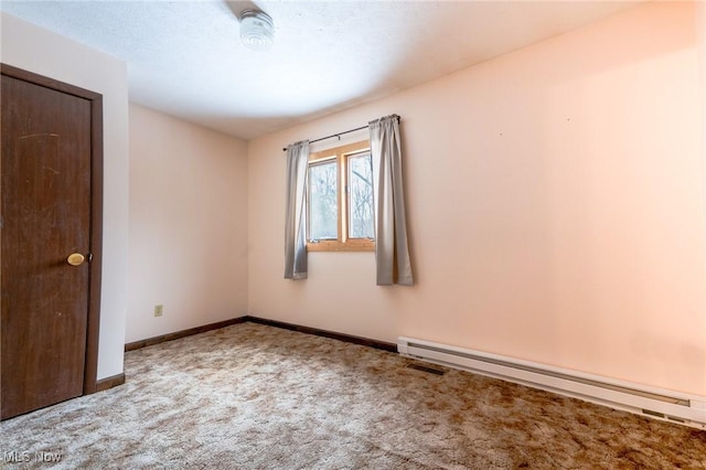 carpeted empty room with baseboard heating