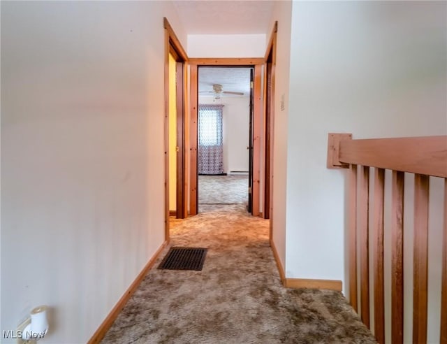 hall with light colored carpet