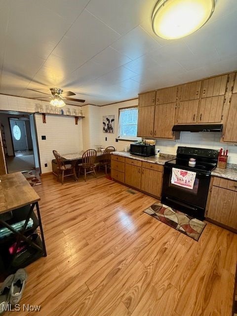 kitchen with light hardwood / wood-style floors, black appliances, and ceiling fan