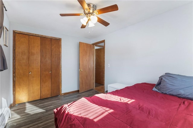 bedroom with ceiling fan, a baseboard radiator, dark hardwood / wood-style floors, and a closet