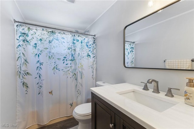 full bathroom with toilet, ornamental molding, vanity, and shower / tub combo with curtain