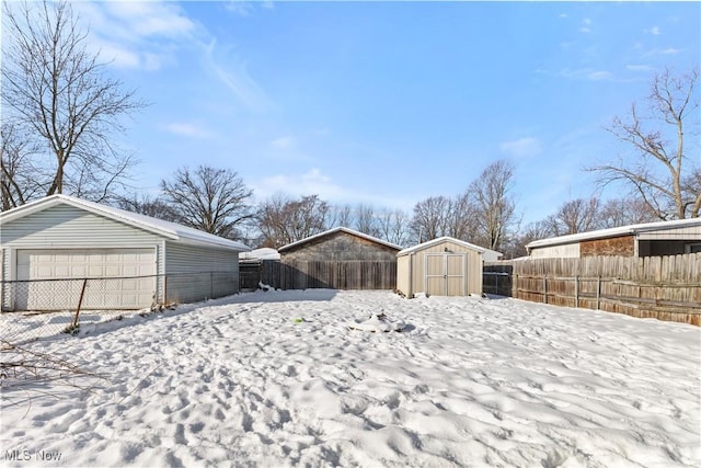 yard covered in snow featuring a storage shed