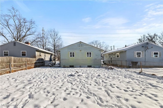 view of snow covered back of property