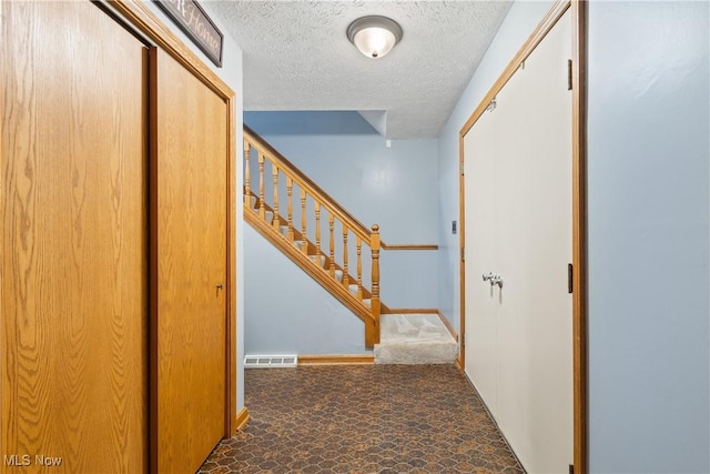 corridor with a textured ceiling