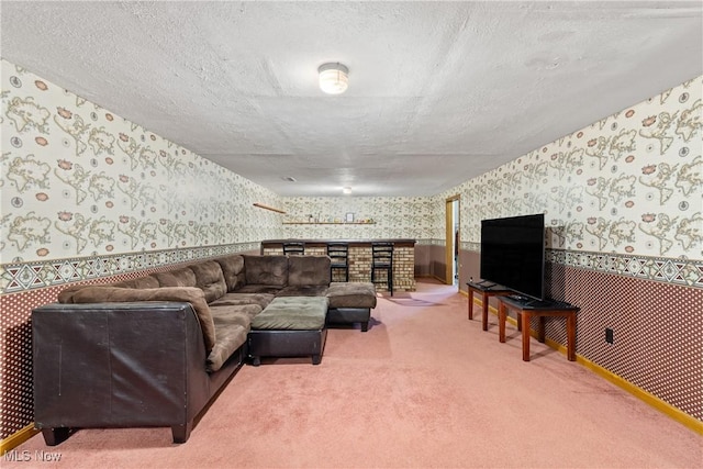 carpeted living room featuring a textured ceiling