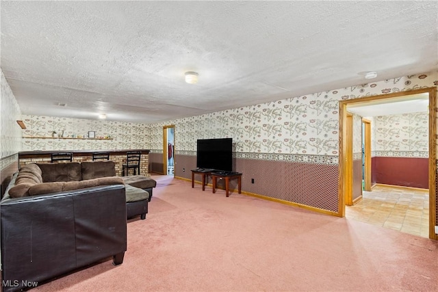 living room with a textured ceiling and carpet flooring