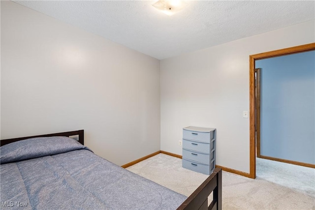 carpeted bedroom featuring a textured ceiling