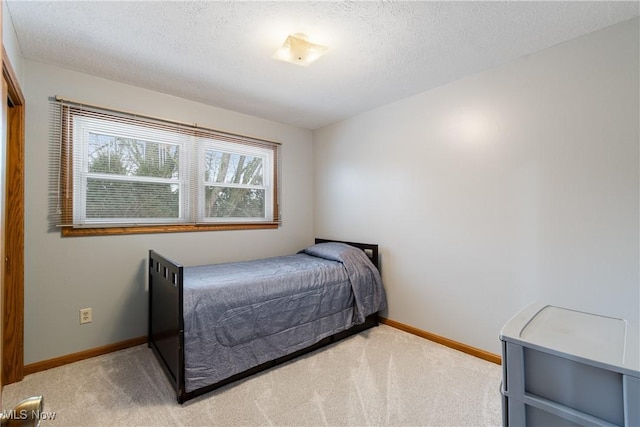 bedroom with carpet floors and a textured ceiling