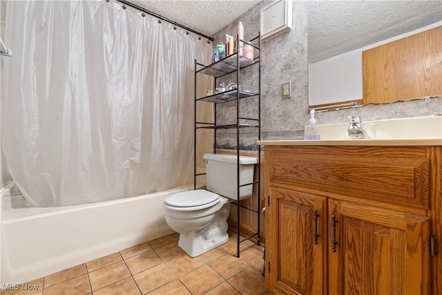 full bathroom featuring toilet, vanity, tile patterned floors, shower / bath combination with curtain, and a textured ceiling