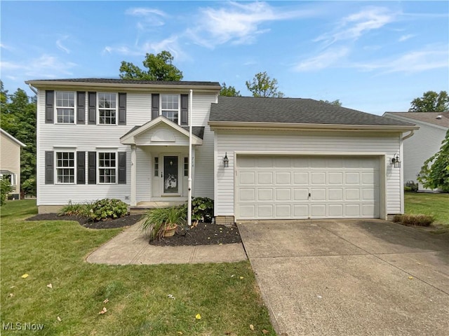 view of front of house with a front lawn and a garage