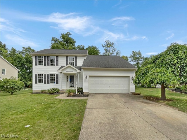 colonial inspired home featuring a front yard and a garage