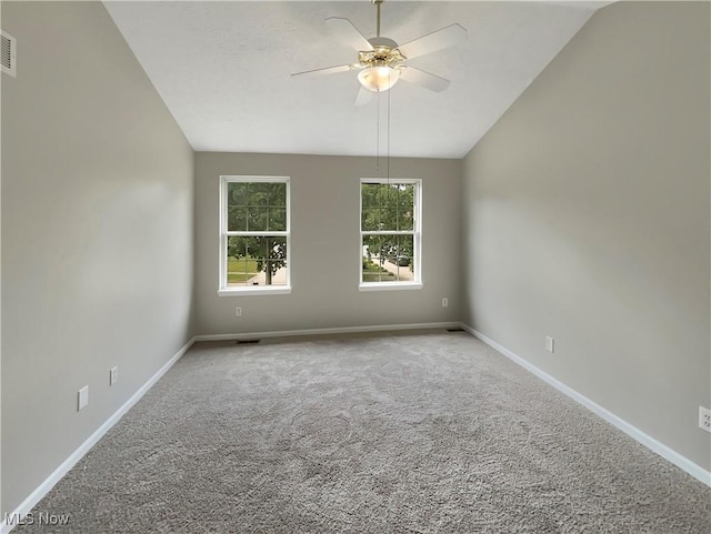 spare room with ceiling fan, carpet flooring, and lofted ceiling