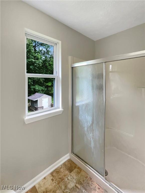 bathroom with a shower with shower door